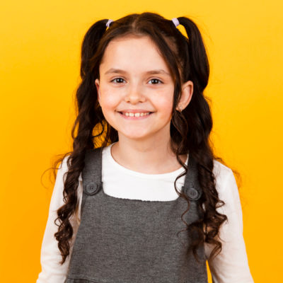 portrait-little-girl-smiling-with-pigtails-hair